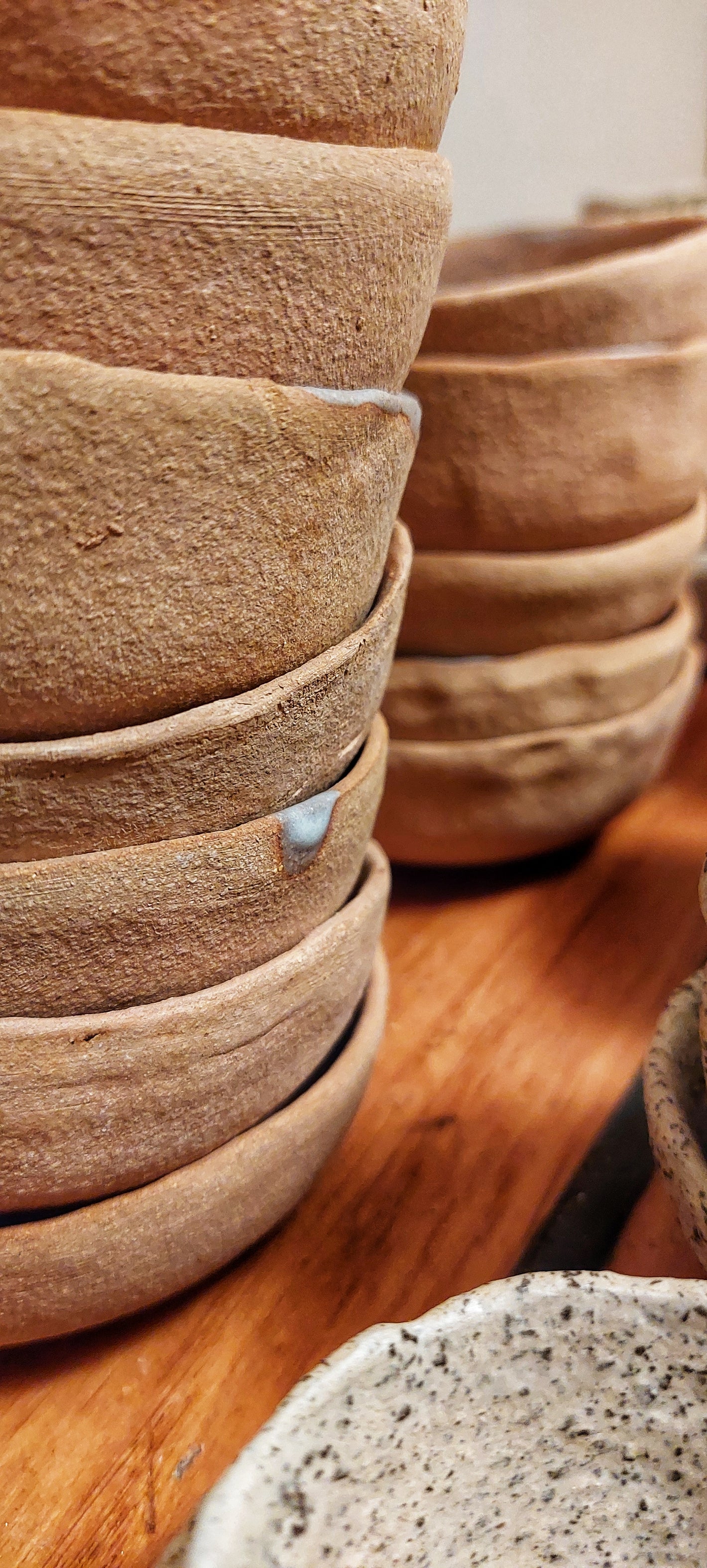 Stacked ceramic pots on a wooden surface